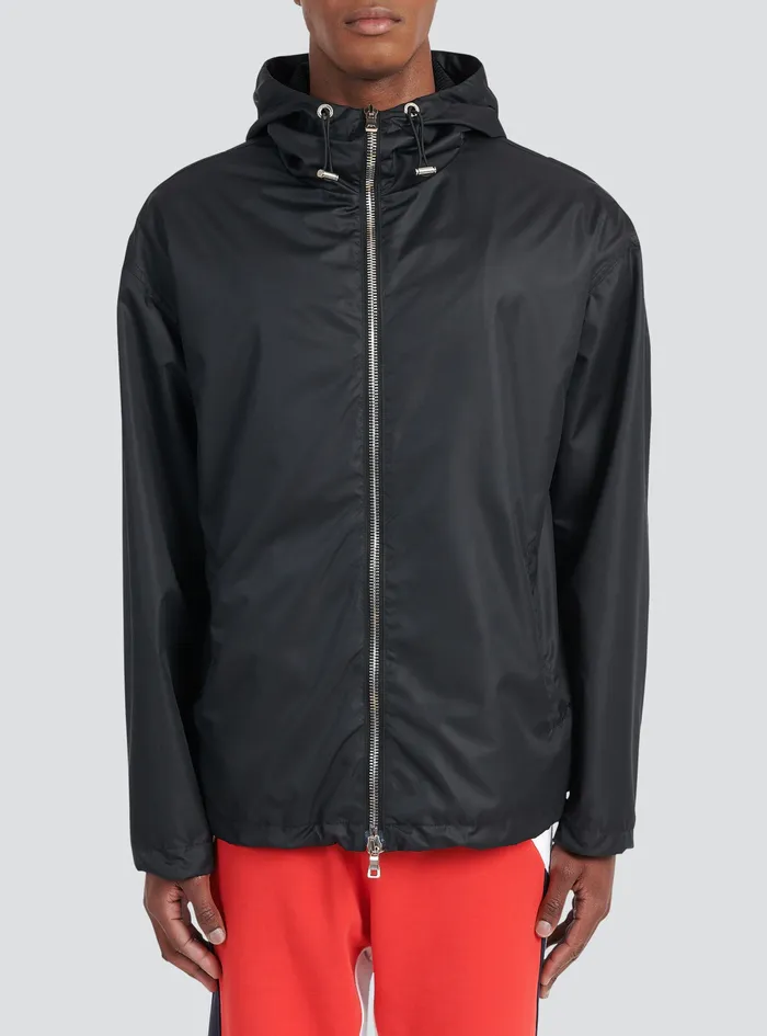 Balmain Outerwear Mens Hooded Nylon Windbreaker With Transparent Balmain Logo Black Balmain Outerwear Mens Hooded Nylon Windbreaker With Transparent Balmain Logo Black