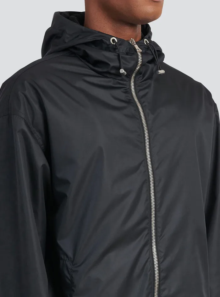 Balmain Outerwear Mens Hooded Nylon Windbreaker With Transparent Balmain Logo Black Balmain Outerwear Mens Hooded Nylon Windbreaker With Transparent Balmain Logo Black