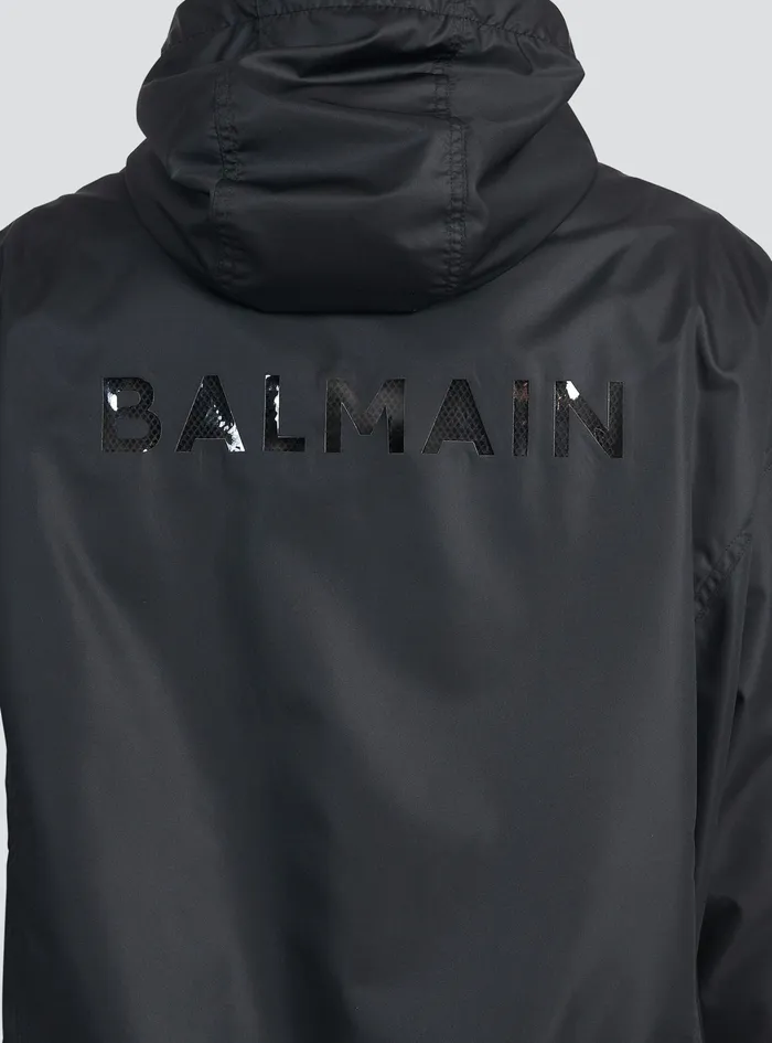 Balmain Outerwear Mens Hooded Nylon Windbreaker With Transparent Balmain Logo Black Balmain Outerwear Mens Hooded Nylon Windbreaker With Transparent Balmain Logo Black